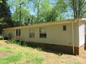 The house has neutral siding and a brick foundation; natural light streams through the multiple windows at 6293 Karen Dr, Claremont, NC 28610