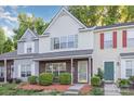 Charming two-story townhome with brick accents, neutral siding, and manicured landscaping at 7607 Petrea Ln, Charlotte, NC 28227