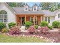 Charming front porch with natural wood detail, flowering shrubs, and rocking chairs at 812 Timber Creek Dr, York, SC 29745
