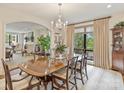 Formal dining room with a chandelier, large window, and view to the living room at 916 Cherokee Rd, Charlotte, NC 28207