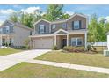 Charming two-story home with brick and siding, a well-maintained lawn, and an attached two-car garage at 1020 Clementine Rd, Monroe, NC 28110