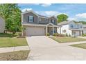 Attractive two-story home with brick and siding, attached garage, and well-maintained lawn in a suburban neighborhood at 1020 Clementine Rd, Monroe, NC 28110
