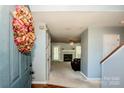 Inviting foyer leading to a comfortable living area with fireplace and neutral decor at 11024 Hunters Trace None, Charlotte, NC 28262