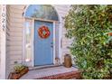 Welcoming front door with wreath and arched window, complemented by mature landscaping at 11024 Hunters Trace None, Charlotte, NC 28262