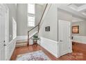 Bright entryway with hardwood floors, a staircase, and neutral paint, creating a welcoming ambiance at 1105 Hoyle Ln, Waxhaw, NC 28173