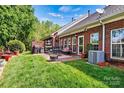 Relaxing outdoor patio with grill and table in a lush backyard at 1119 21St Ne Ave, Hickory, NC 28601