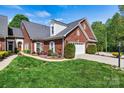 Charming brick home with a well-manicured lawn and a two-car attached garage at 1119 21St Ne Ave, Hickory, NC 28601