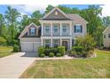 Beautiful two-story home with a spacious front yard, manicured bushes, and a two-car garage at 112 Serravista St, Mooresville, NC 28117