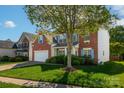Charming brick home with blue shutters and lush green lawn on a sunny day at 12404 Mcallister Park Dr, Charlotte, NC 28277