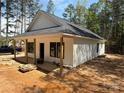 Bright home featuring white siding, a covered front porch, and an unfinished landscape at 148 Forest Meadow Ln, Salisbury, NC 28144