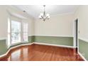 Spacious dining area featuring ample natural light, hardwood floors, and a stylish chandelier at 2003 Dataw Ln, Indian Trail, NC 28079