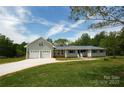Charming house featuring an attached two-car garage, complemented by a well-manicured lawn and a long driveway at 2019 Kingston Rd, Kingstown, NC 28150