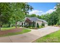 Spacious home with an expansive driveway and well-maintained landscaping, offering plenty of parking. Three-car garage at 206 Oxford Place Dr, Fort Mill, SC 29715