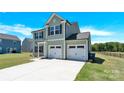 Charming two-story home features a two-car garage, well-maintained lawn, and welcoming curb appeal at 207 Aspire Cir # 46, Wingate, NC 28174