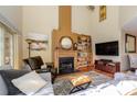 Spacious living room with a cozy fireplace, wooden floors, a large window and comfortable seating at 217 W 8Th St, Charlotte, NC 28202