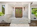 Elegant double front door with sidelights framed by white painted brick and exterior lanterns at 2411 Ainsdale Rd, Charlotte, NC 28226