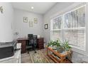 Bright home office with natural light, desk, plants, and a printer at 247 Timberland Loop, Mooresville, NC 28115