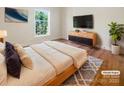 Cozy bedroom with a comfortable bed, modern dresser, TV, and a serene window view at 249 Arrowood Ave, Lancaster, SC 29720