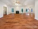 Bright living room with wood floors, a fireplace, and ample natural light at 249 Arrowood Ave, Lancaster, SC 29720