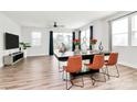 Open-concept dining area with hardwood floors and large windows, perfect for entertaining guests at 2520 Ensemble Ct, Charlotte, NC 28262