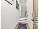 Bright entryway with hardwood floors, white walls, and staircase leading to the upper level at 2520 Ensemble Ct, Charlotte, NC 28262