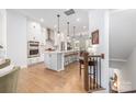 Bright open kitchen boasts a spacious island, stainless steel appliances, and light hardwood flooring at 2558 Deacon Ave, Charlotte, NC 28204