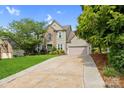 Beautiful two-story home featuring a brick and siding exterior, a spacious driveway, and manicured landscaping at 2710 Providence Spring Ln, Charlotte, NC 28270