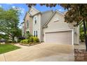 A view of the side of the house shows the driveway leading up to a 2-car garage at 2710 Providence Spring Ln, Charlotte, NC 28270