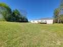 Well-maintained single-story home featuring an expansive grassy yard and a front deck at 2822 Hugh Rd, Shelby, NC 28150