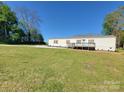 Single-story home with a welcoming front deck, set on a spacious green lawn at 2822 Hugh Rd, Shelby, NC 28150