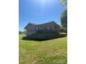 Exterior view with brick finishes, surrounded by an extensive grassy yard at 28344 Canton Rd, Albemarle, NC 28001
