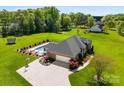 Spacious backyard features a private pool and manicured landscaping, surrounded by lush greenery and a large driveway at 3003 Eaker Dr, Cherryville, NC 28021