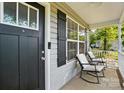 Cozy front porch features rocking chairs and a view of the yard, perfect for relaxing outdoors at 303 Caroline Ave, Lowell, NC 28098