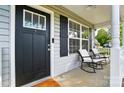 Inviting front porch with rocking chairs, offering a relaxing outdoor space with a view of the neighborhood at 303 Caroline Ave, Lowell, NC 28098