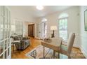Bright home office with hardwood floors, white trim, and arched windows at 3233 Sunnymede Ln, Charlotte, NC 28209