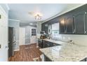 Modern kitchen featuring stainless steel appliances, dark cabinetry, and granite countertops at 3619 Baywoods Ct, Gastonia, NC 28056