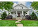 Beautiful home featuring a large front porch with decorative columns and well-manicured lawn at 365 Delburg St, Davidson, NC 28036