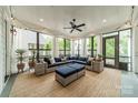 Cozy sunroom with large windows, comfortable seating, and natural light at 365 Delburg St, Davidson, NC 28036