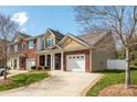 Charming brick townhome with manicured front yard, front-entry two-car garage, and a cozy front porch at 4015 Broadview Ln, Gastonia, NC 28056