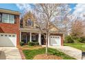 Charming brick townhome with manicured front yard, front-entry two-car garage, and a cozy front porch at 4015 Broadview Ln, Gastonia, NC 28056