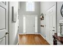 Bright foyer featuring hardwood floors, high ceilings, a large window, and a white front door at 503 Azure Ave, Albemarle, NC 28001