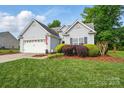 Charming single-Gathering home featuring a two-car garage, well-maintained lawn, and traditional siding at 503 Azure Ave, Albemarle, NC 28001