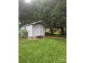 A small shed in the backyard of a home, nestled among tall trees at 503 Azure Ave, Albemarle, NC 28001
