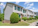 Attractive townhouse featuring green shutters, complemented by well-maintained landscaping and a sidewalk at 513 Lex Dr, Charlotte, NC 28262