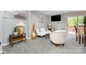 Cozy living room featuring plush carpeting, modern decor, and a sliding glass door to the outside at 513 Lex Dr, Charlotte, NC 28262