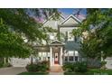 Charming two-story home featuring a red front door, manicured lawn, and an inviting porch with an American flag at 5301 Meadowcroft Way, Fort Mill, SC 29708