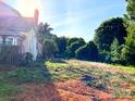 Spacious backyard with trees and an old fence in need of landscaping at 6000 S Main St, Salisbury, NC 28147