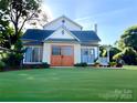 Lovely two-story home with a pristine lawn and cozy front porch at 6000 S Main St, Salisbury, NC 28147