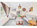Cozy living room featuring neutral tones, stylish furniture, carpet flooring, and ample natural light at 6222 Ohaus Ct # 59, Charlotte, NC 28216