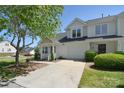 Two-story townhome with attached garage and a well-maintained lawn in a neighborhood at 6631 Vlosi Dr, Charlotte, NC 28226